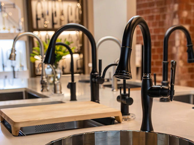 Multiple kitchen sink faucets on display in the Weinstein Willow Grove Kitchen & Bath Showroom